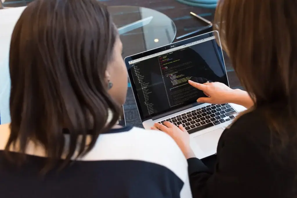 Two specialists reviewing application code together